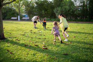 Parents playing outdoors with their children