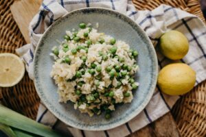 A bowl of fluffy rice combined with bright green peas.