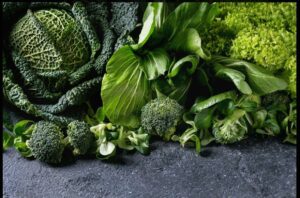  An array of fresh vegetables set on a striking black surface