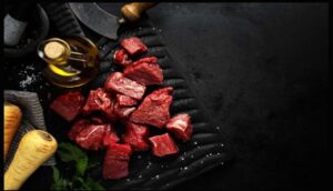  Fresh raw beef on a dark background, showcasing its vibrant red hue and marbling details